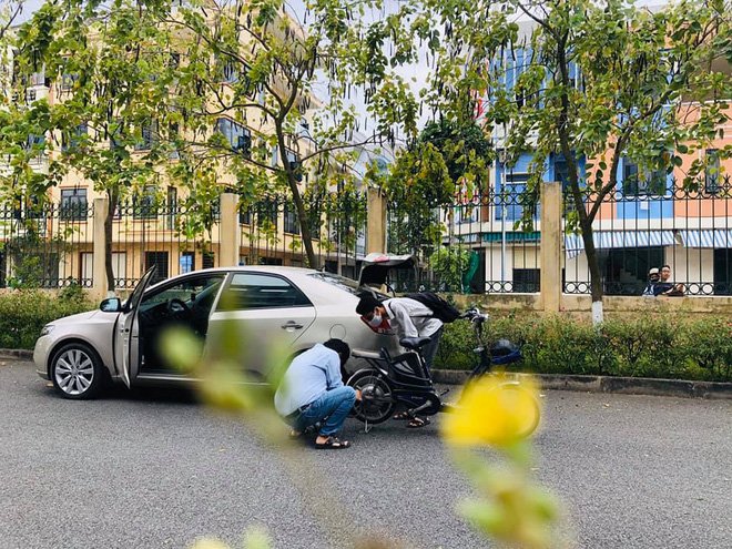 Xúc động hình ảnh thầy giáo xuống ô tô, ngồi sửa xe đạp cho học trò giữa trưa nắng như đổ lửa - Ảnh 1. Xúc động hình ảnh thầy giáo xuống ô tô, ngồi sửa xe đạp cho học trò giữa trưa nắng như đổ lửa - Ảnh 1.